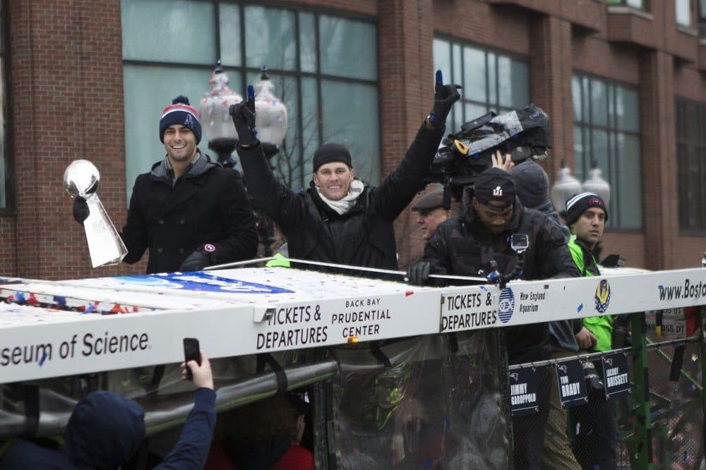 The three Patriots quarterbacks Tom Brady (center) points his fingers, Jimmy Garropolo (l) holds the Superbowl trophy and Jacoby Brisette. (Jesse Costa/WBUR)