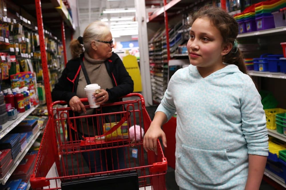 Mellanie Rodriguez, Francisco Rodriguez's 10-year-old daughter, goes shopping for school supplies at Staples with her grandmother, Jesus Rodriguez, on Saturday, October 14th. (Hadley Green for WBUR)