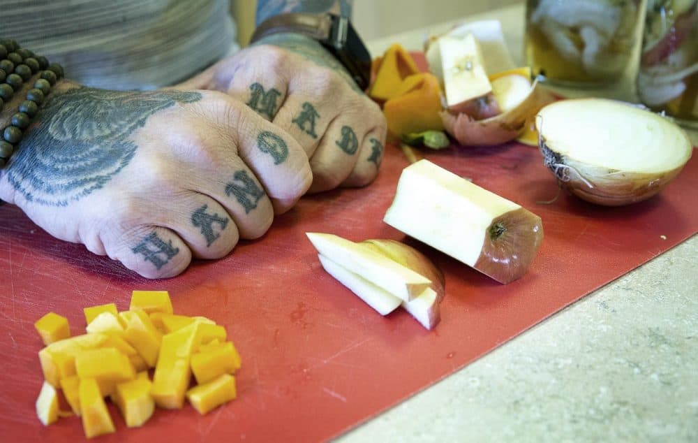 Chef Matt Jennings' hands on a cutting board at WBUR. (Robin Lubbock/WBUR)