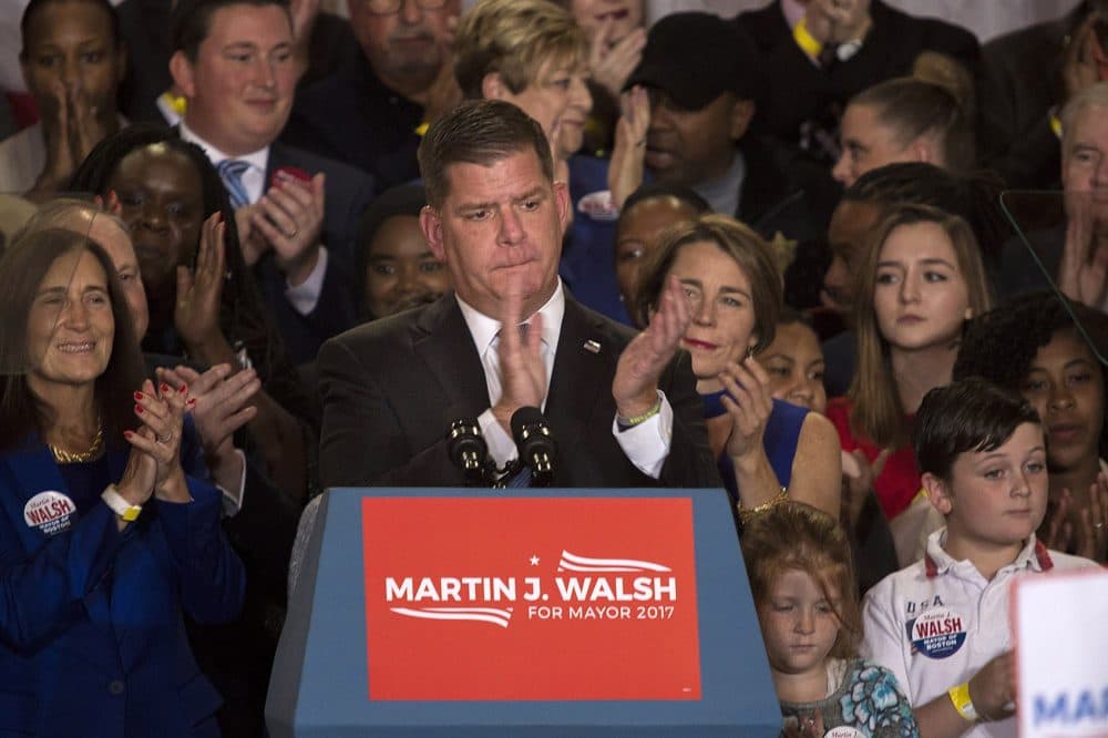 Boston Mayor Marty Walsh applauds the crowd after winning for a second term. (Jesse Costa/WBUR)