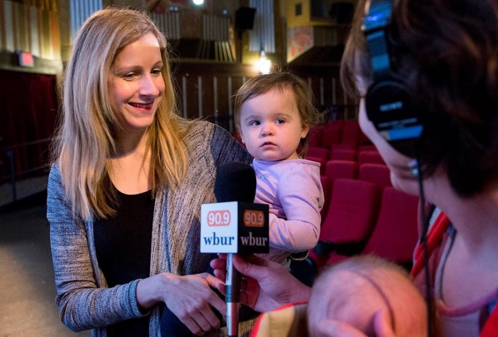 The Coolidge Corner Theatre's Beth Gilligan, and her 18-month-old daughter Laura, talk with arts reporter Erin Trahan and her 2-month-old son Zed, just before the lights go down for a screening of &quot;Faces Places.&quot; (Robin Lubbock/WBUR)