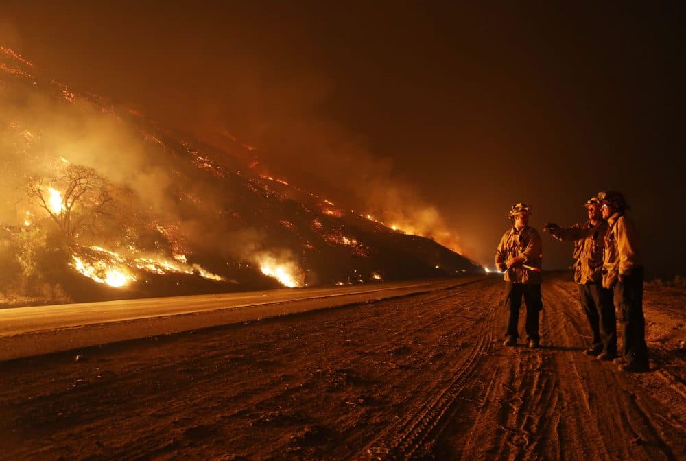 Firefighters monitor a section of the Thomas Fire along the 101 freeway on Dec. 7, 2017 north of Ventura, Calif. Strong Santa Ana winds are rapidly pushing multiple wildfires across the region, expanding across tens of thousands of acres and destroying hundreds of homes and structures. (Mario Tama/Getty Images)