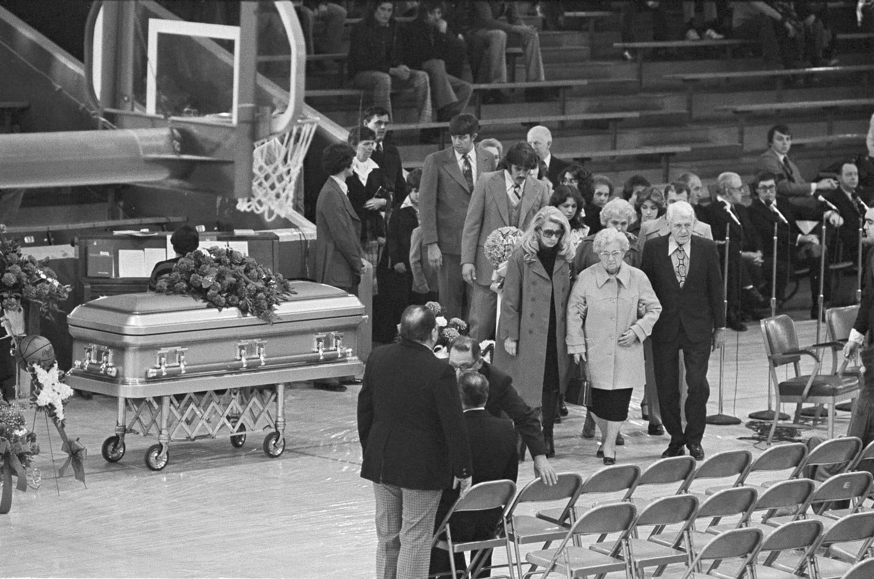 The family members of University of Evansville basketball player Kevin Kingston pass his casket as they arrive at a memorial service for Kingston and Mike Duff at the Eldorado High School gym in Eldorado, Ill., Dec. 17, 1977. (Brian Horton/AP)