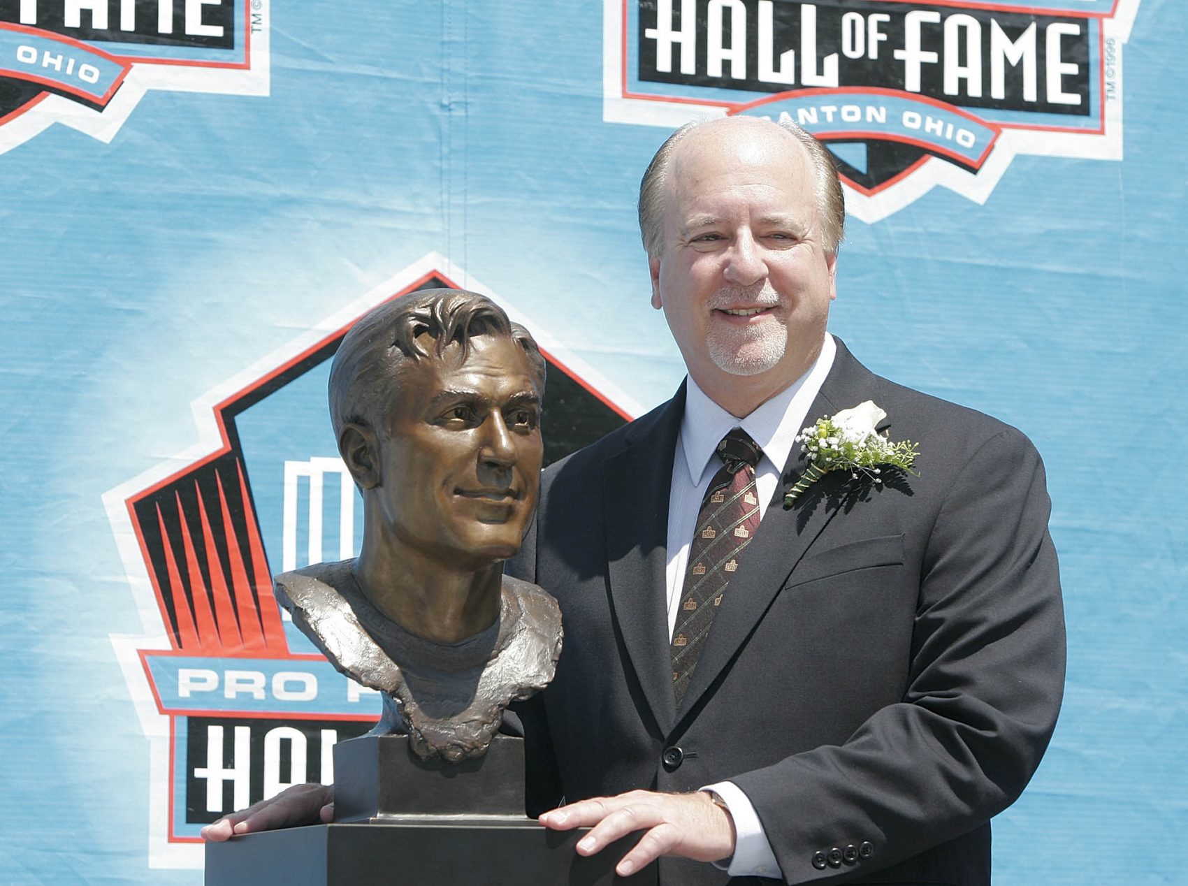 David Friedman, Benny's nephew, stands next to the quarterback's bust at the Pro Football Hall of Fame in 2005. (Kiichiro Sato/AP)