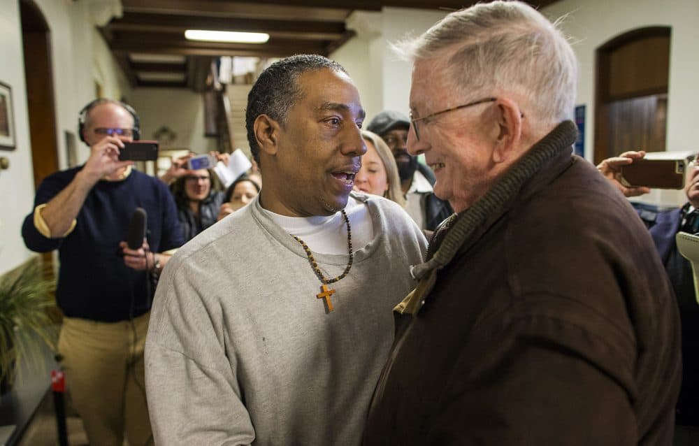 Darrell Jones embraces Rev. William Barry, who he calls "Dad," following his release on bail in 2017 after serving 32 years in prison. Tuesday, jurors found him not guilty in his retrial. (Jesse Costa/WBUR)
