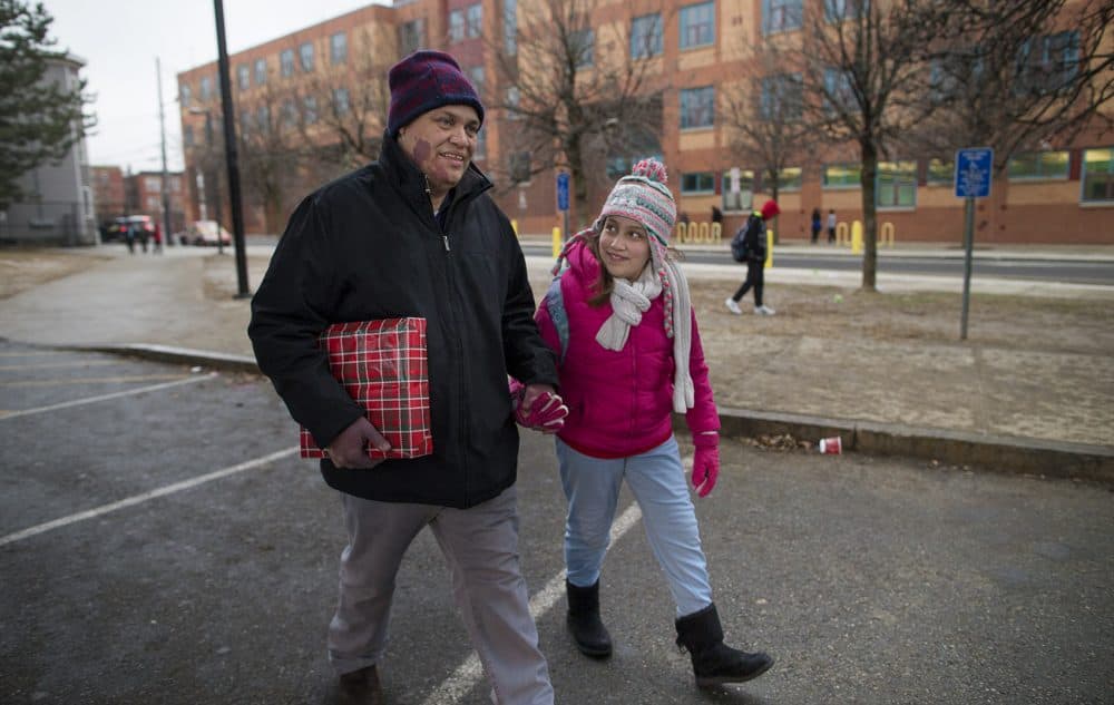 Francisco Rodriguez, an undocumented immigrant, picks up his daughter from school in Chelsea after being released from immigration custody. He still faces deportation. (Jesse Costa/WBUR)