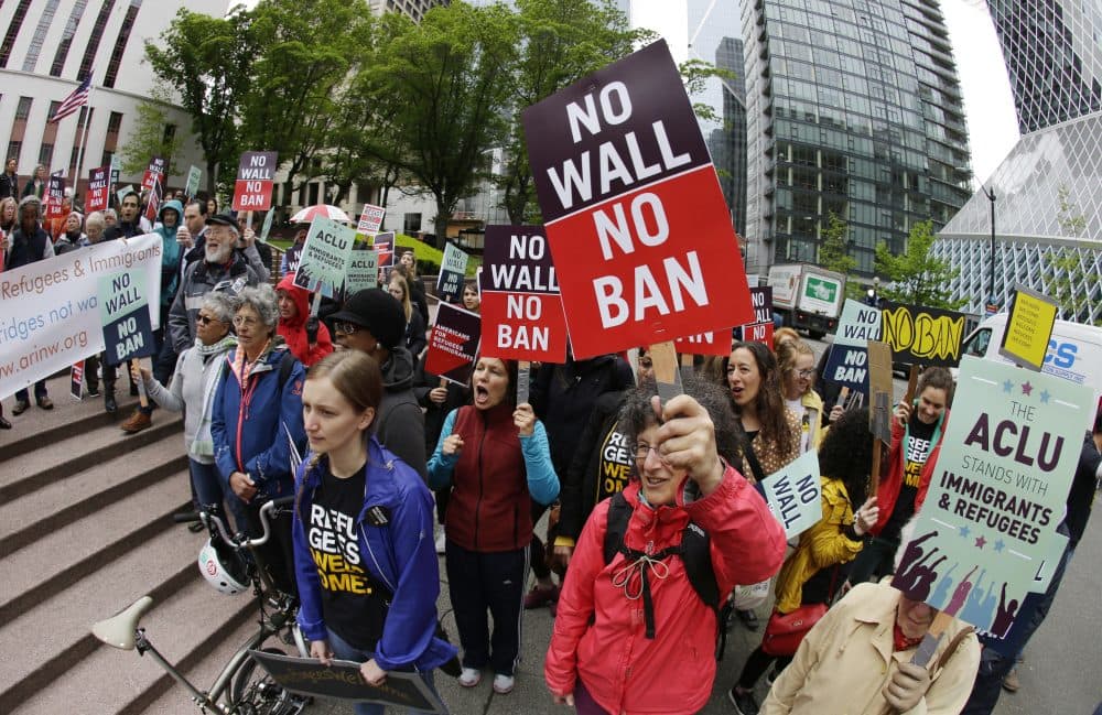 In this May 15, 2017, file photo, protesters wave signs and chant during a demonstration against President Donald Trump's revised travel ban outside a federal courthouse in Seattle. (Ted S. Warren/AP)