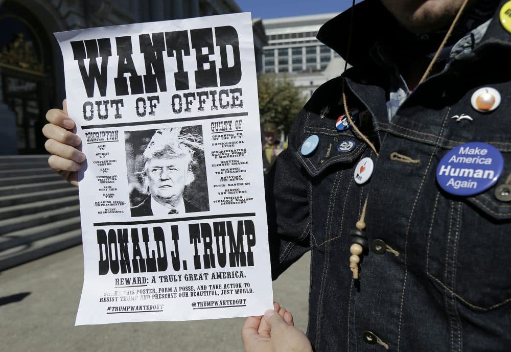 Andrew Fitch holds up a sign at a rally calling for the impeachment of President Donald Trump in San Francisco, Tuesday, Oct. 24, 2017. (Jeff Chiu/AP)