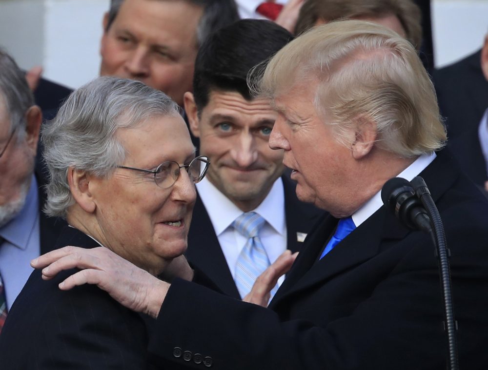 President Donald Trump congratulates Senate Majority Leader Mitch McConnell of Ky., while House Speaker Paul Ryan of Wis., watches to acknowledge the final passage of tax overhaul legislation by Congress at the White House in Washington, Wednesday, Dec. 20, 2017. (Manuel Balce Ceneta/AP)