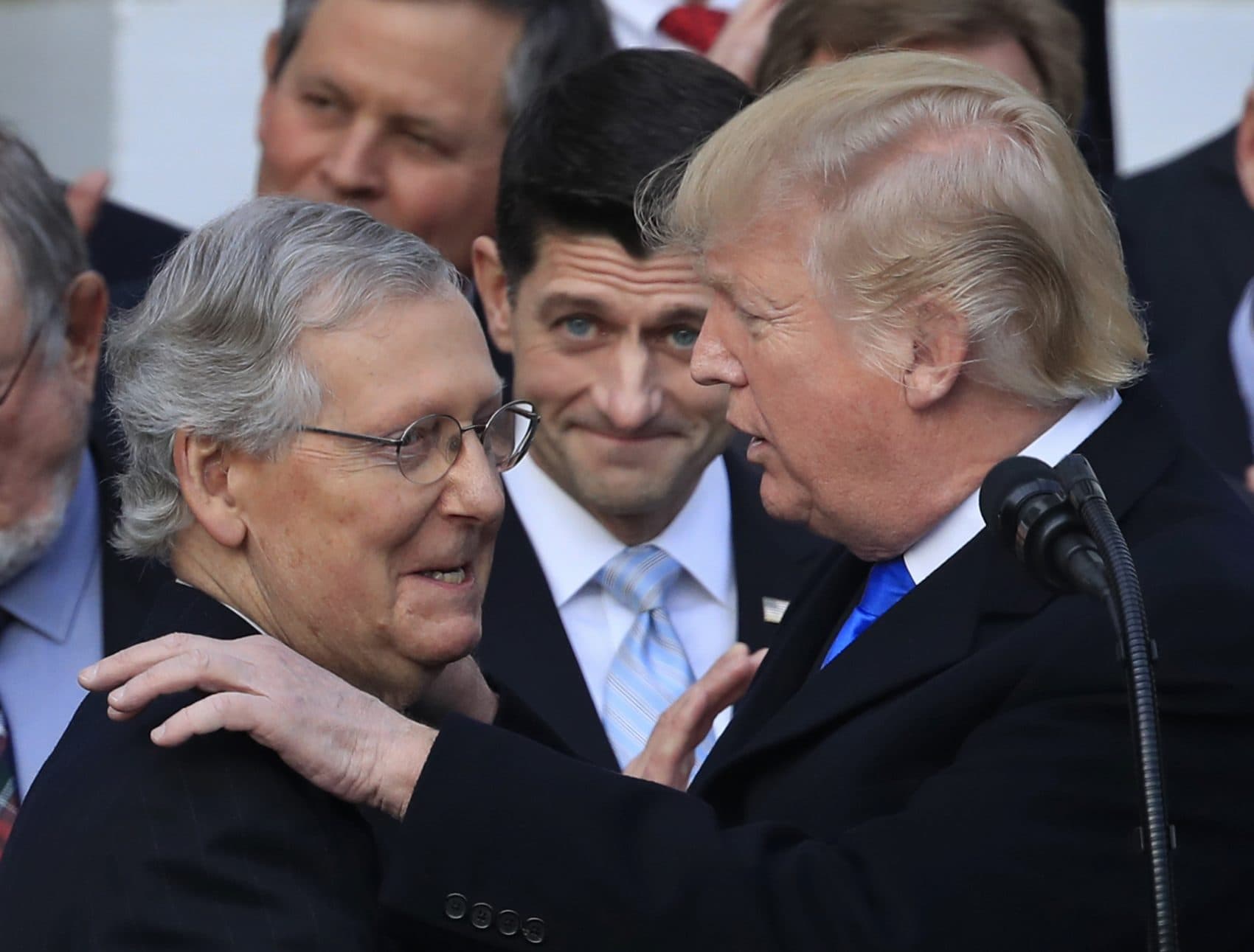 President Donald Trump congratulates Senate Majority Leader Mitch McConnell of Ky., while House Speaker Paul Ryan of Wis., watches to acknowledge the final passage of tax overhaul legislation by Congress at the White House in Washington, Wednesday, Dec. 20, 2017. (Manuel Balce Ceneta/AP)