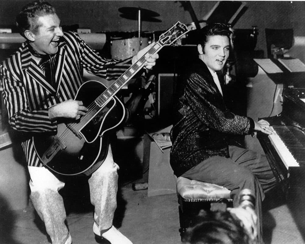 Piano virtuoso Liberace is shown playing the guitar with Elvis Presley at the piano in November 1956 at the Riviera Hotel in Las Vegas. (AP)