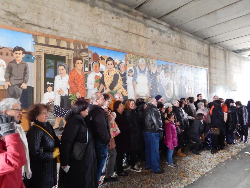 Families and friends of the grandmothers in the mural line up for the unveiling Friday morning. (Phaedra Scott/WBUR)