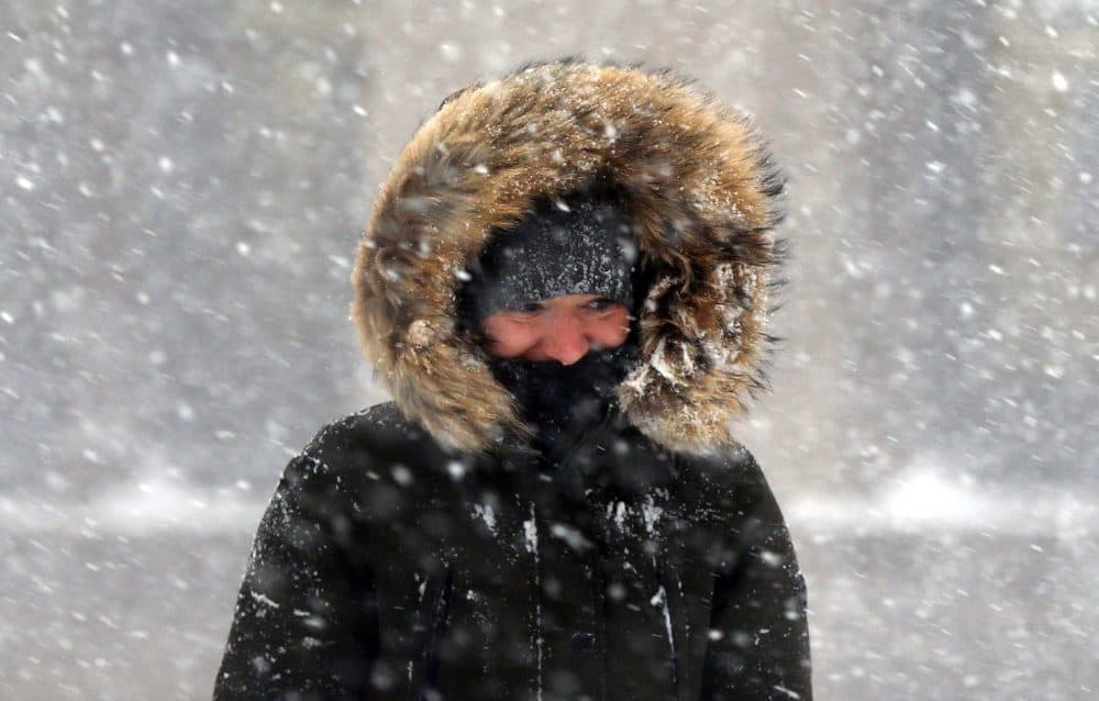 A woman walks in blowing snow in downtown Boston. (Michael Dwyer/AP)