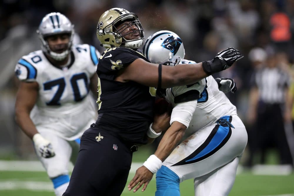 David Onyemata of the New Orleans Saints tackles Cam Newton of the Carolina Panthers on Sunday. (Chris Graythen/Getty Images)