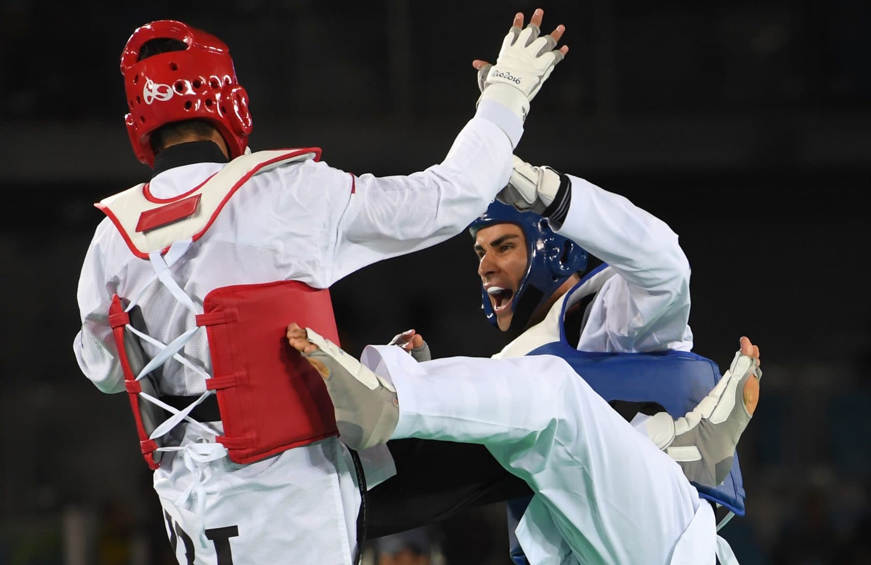 Tonga's Pita Taufatofua (right) competes against Iran's Sajjad Mardani during their men's taekwondo qualifying bout. (Kirill Kudryavtsev/AFP/Getty Images)