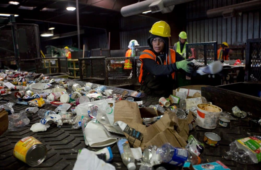 Workers sort paper and plastic waste at Far West Recycling Oct. 30, 2017 in Hillsboro, Ore. China has sharply restricted imports on recycled materials, and the impact will be felt across the Pacific Northwest. (Natalie Behring/Getty Images)