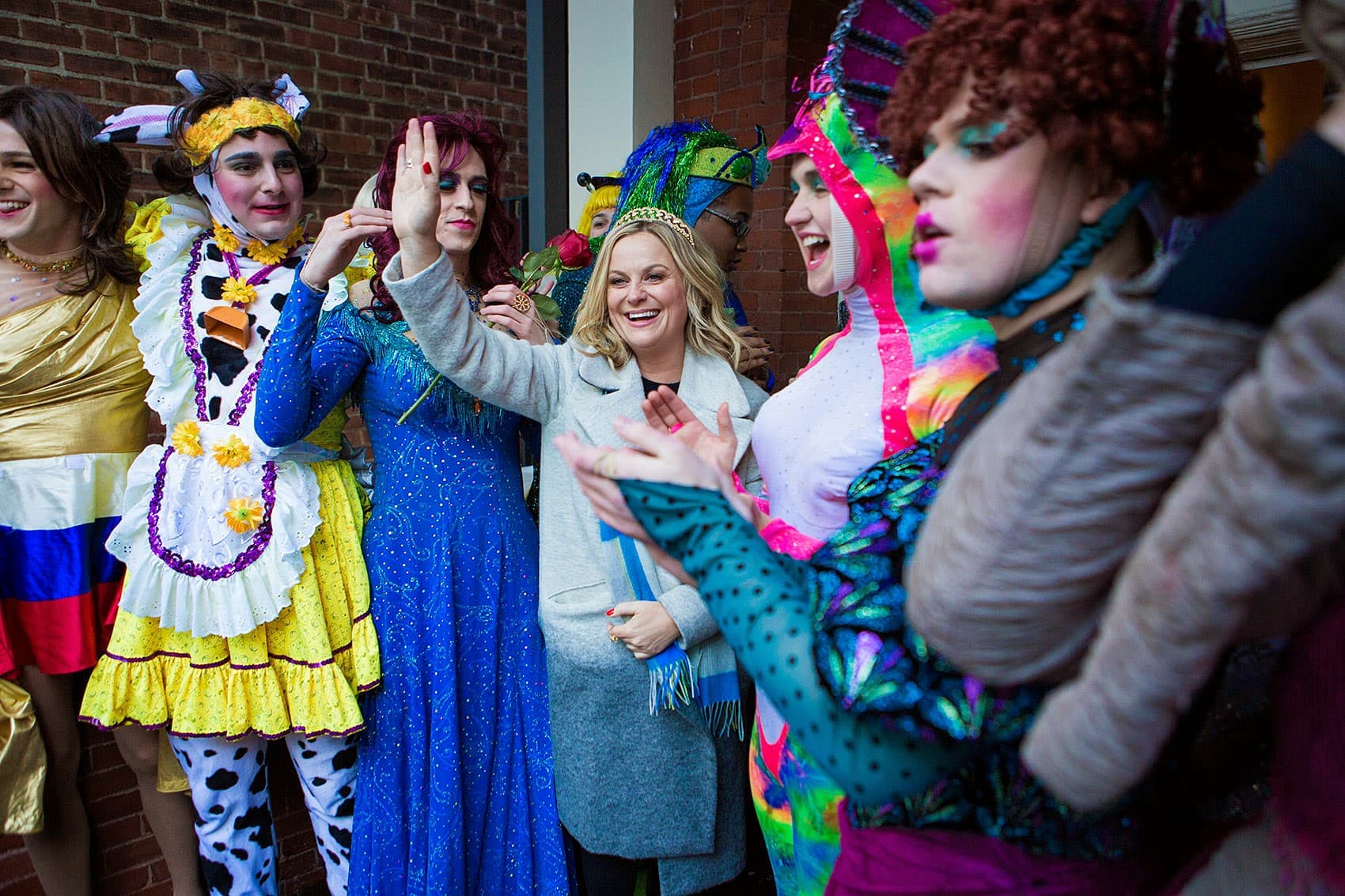 The men of Hasty Pudding dressed in drag stand with Amy Poehler, their 2014 Woman of the Year honoree. (Jesse Costa/WBUR)