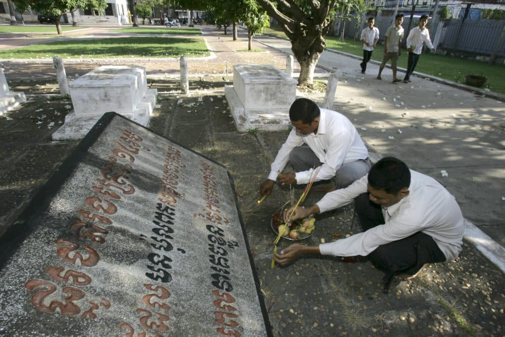 Cambodian officials pray at a grave site in the former Khmer Rouge prison complex, known as S-21, of the Tuol Sleng genocide museum, in Phnom Penh, Cambodia in 2009. The nation was remembering the souls of the thousands of citizens who perished in the notorious Tuol Sleng prison during the reign of the Khmer Rouge. (Heng Sinith/AP)
