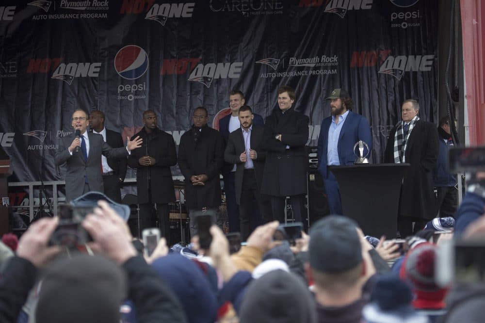 Jonathan Kraft speaks to the crowd as a select number of Patriots players arrive on the stage during the rally. (Jesse Costa/WBUR)
