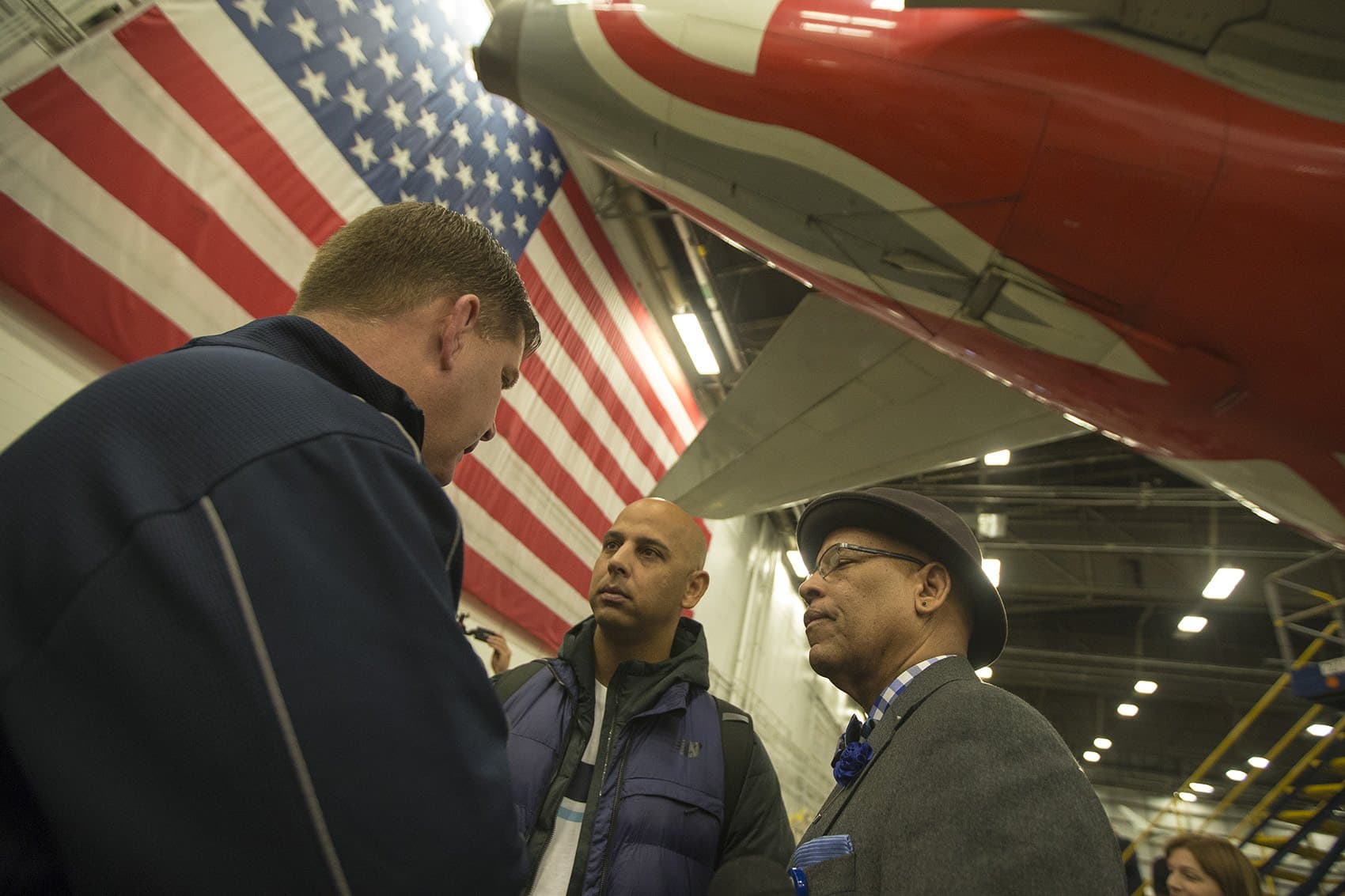 Cora speaks with Walsh and Massport Director of Policy Jose Masso at Logan Airport prior to the trip to Puerto Rico. (Jesse Costa/WBUR)