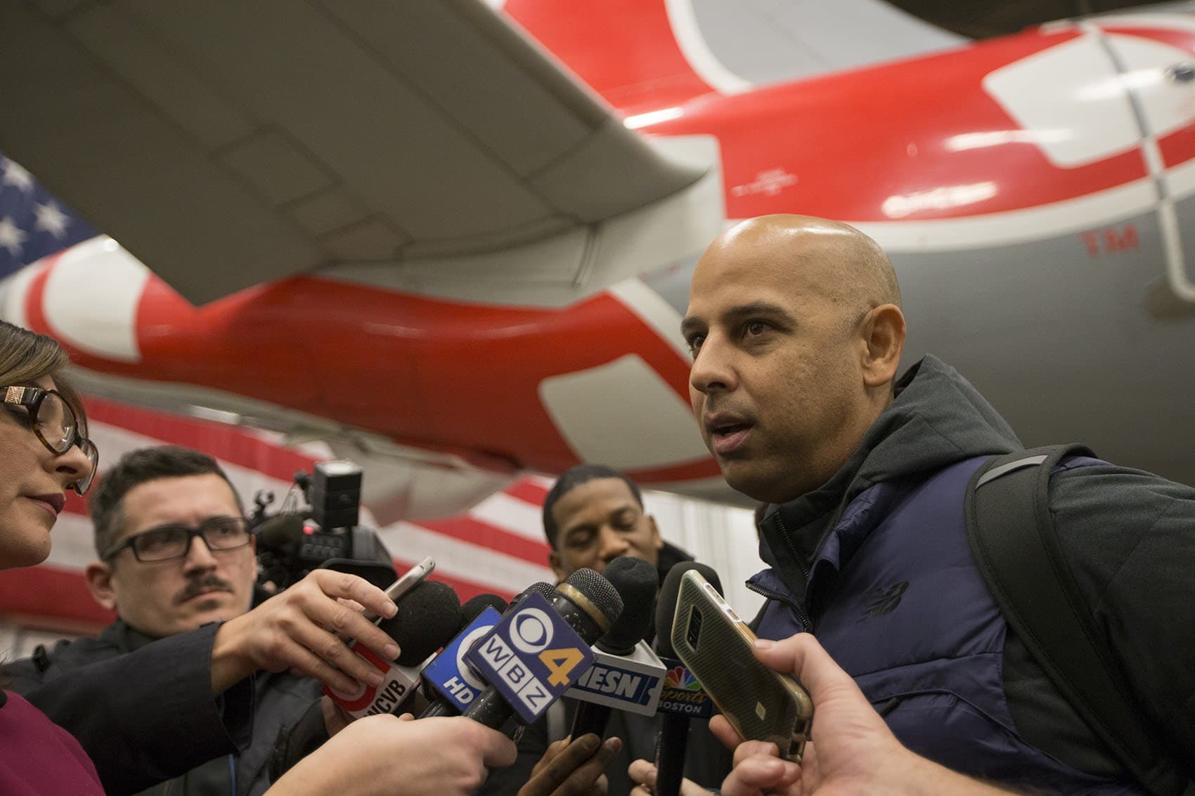 Manager Cora speaks with the media at Logan Airport prior to his trip to Puerto Rico to deliver disaster relief. (Jesse Costa/WBUR)