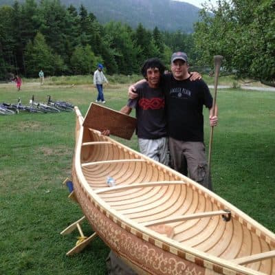 David Moses Bridges, left, with Lars Knakkergaard, standing in front of one of David's hand-crafted canoes. (Courtesy of Knakkergaard)