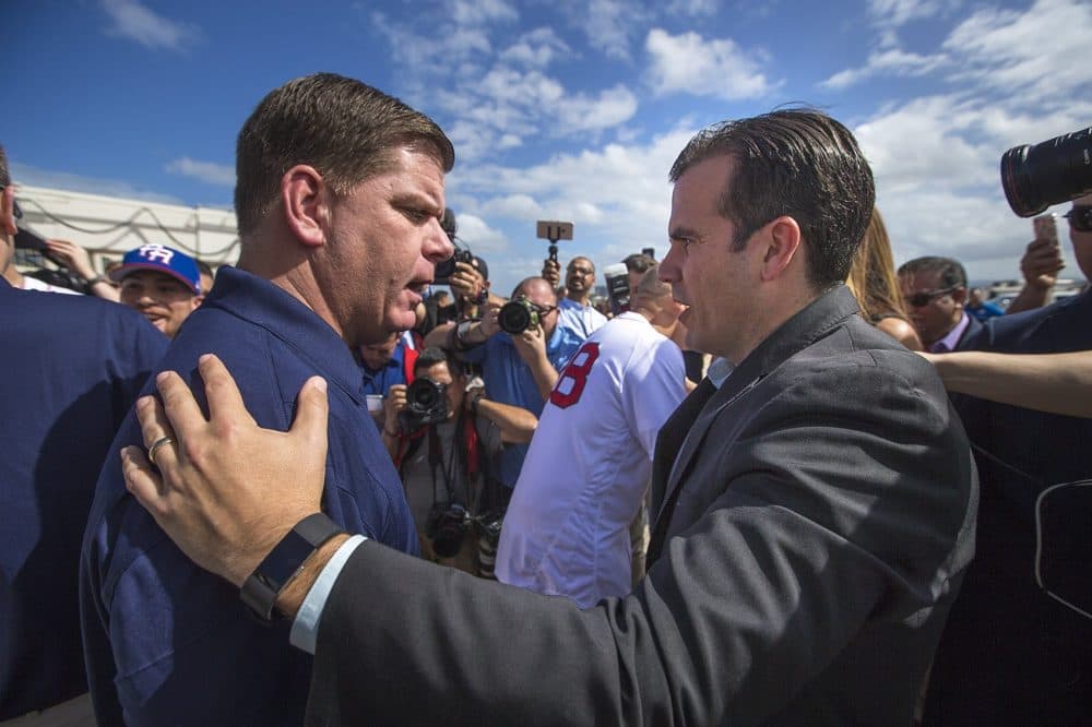 Boston Mayor Marty Walsh is greeted by Puerto Rico Gov. Ricardo Rossello after landing in San Juan. (Jesse Costa/WBUR)