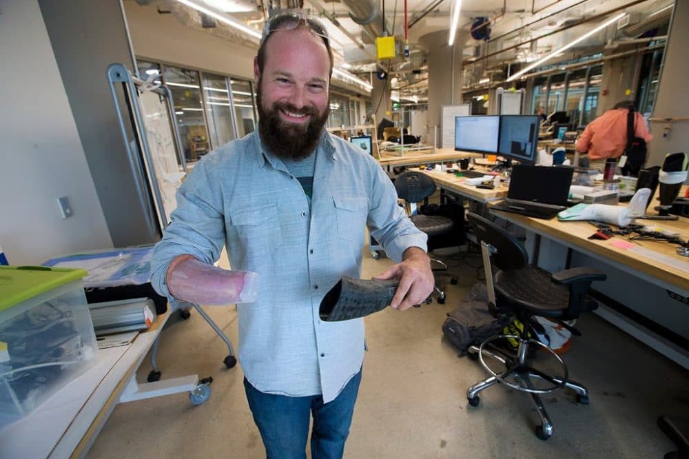 Braden Leonard of Hand Made Prosthetics in Newport, RI demonstrates a new design for a better fitting sleeve for a prosthetic wrist. (Jesse Costa/WBUR)