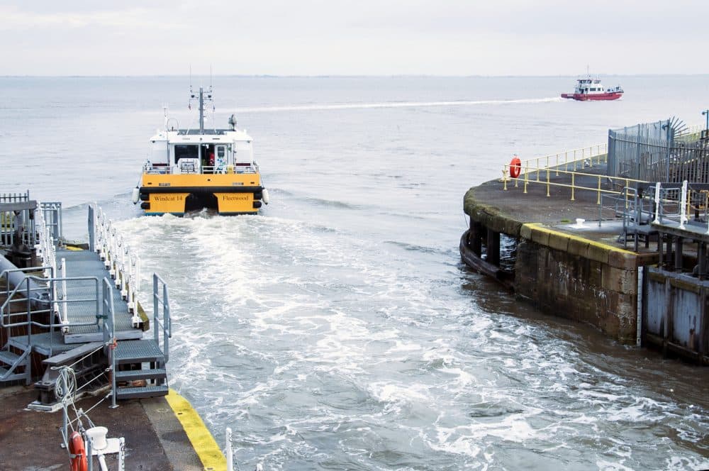 Crew Transfer Vessels (CTVs) ferry wind energy technicians out to offshore wind farms from the Port of Grimsby. (Chris Bentley/WBUR)