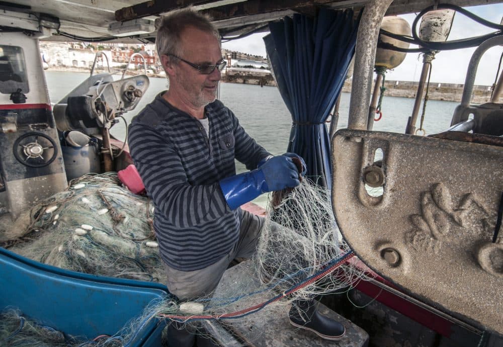 Fisherman Steve Barratt is aboard his boat Razorbill in the Ramsgate harbor. (Chris Bentley for WBUR)