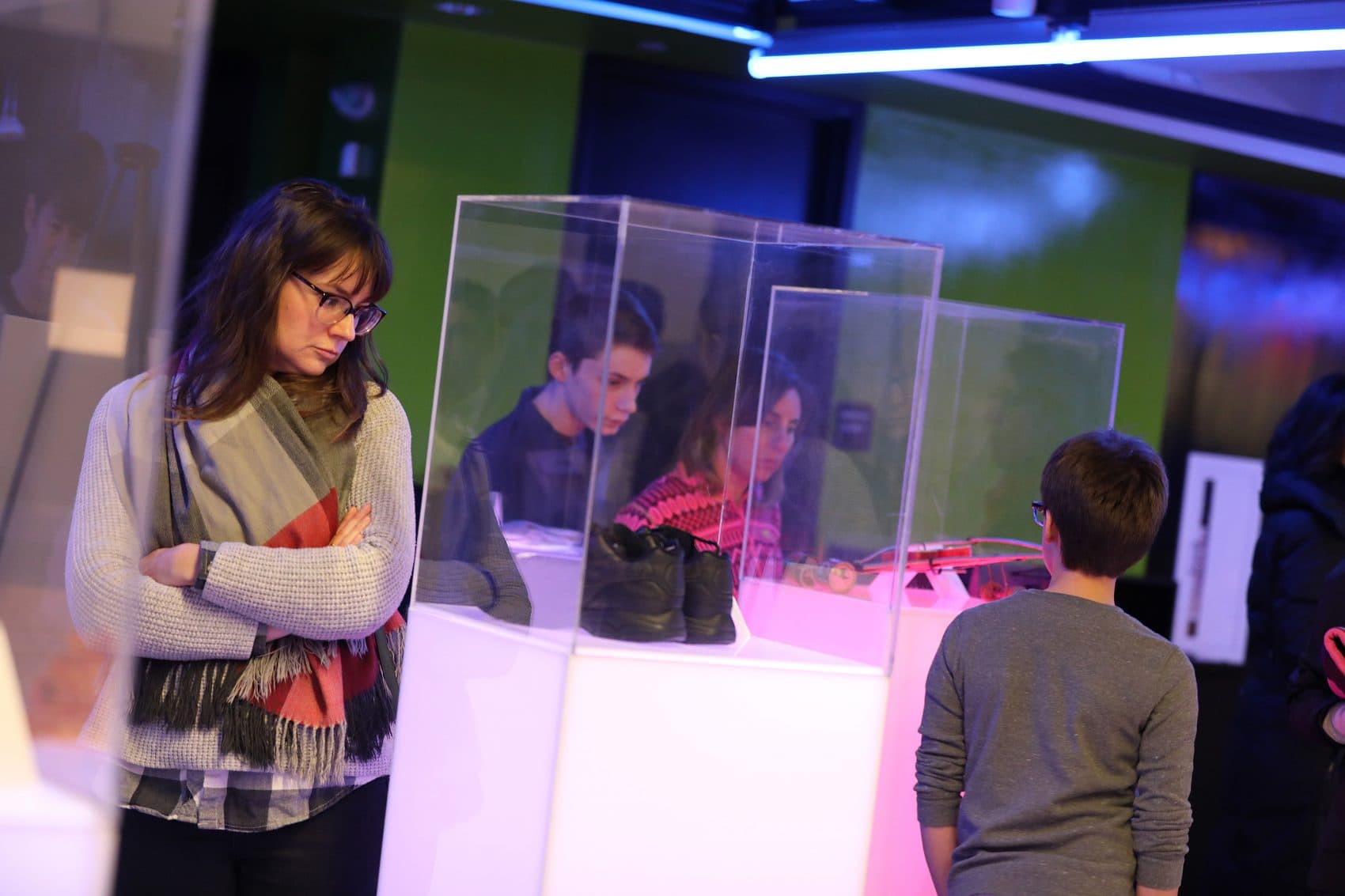 Visitors explore the "Museum Without A Home" at District Hall. (Courtesy Lisa Aimola/Oxfam)