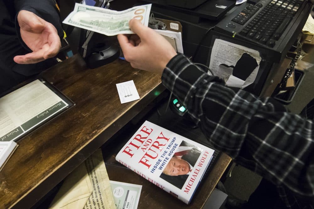 A salesperson takes money to ring up a copy of the book "Fire and Fury: Inside the Trump White House" by Michael Wolff Friday, Jan. 5, 2018. (Matt Rourke/AP)