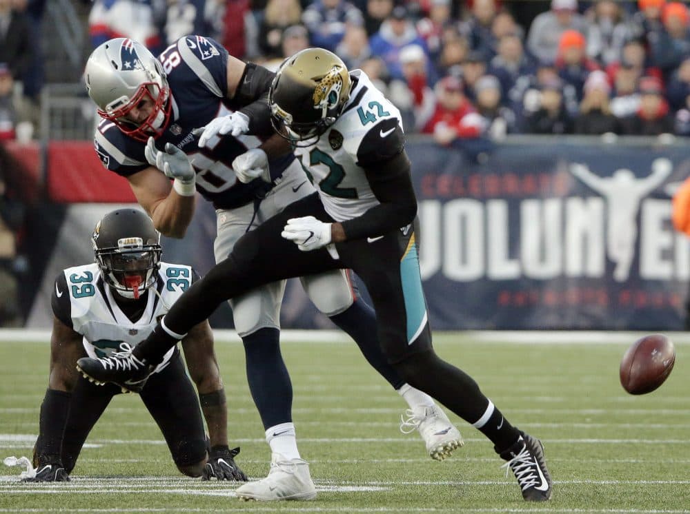 New England Patriots tight end Rob Gronkowski is hit by Jacksonville Jaguars safety Barry Church (42) as he breaks up a pass during the first half of the AFC championship. Gronk suffered a concussion on the play. (Steven Senne/AP)