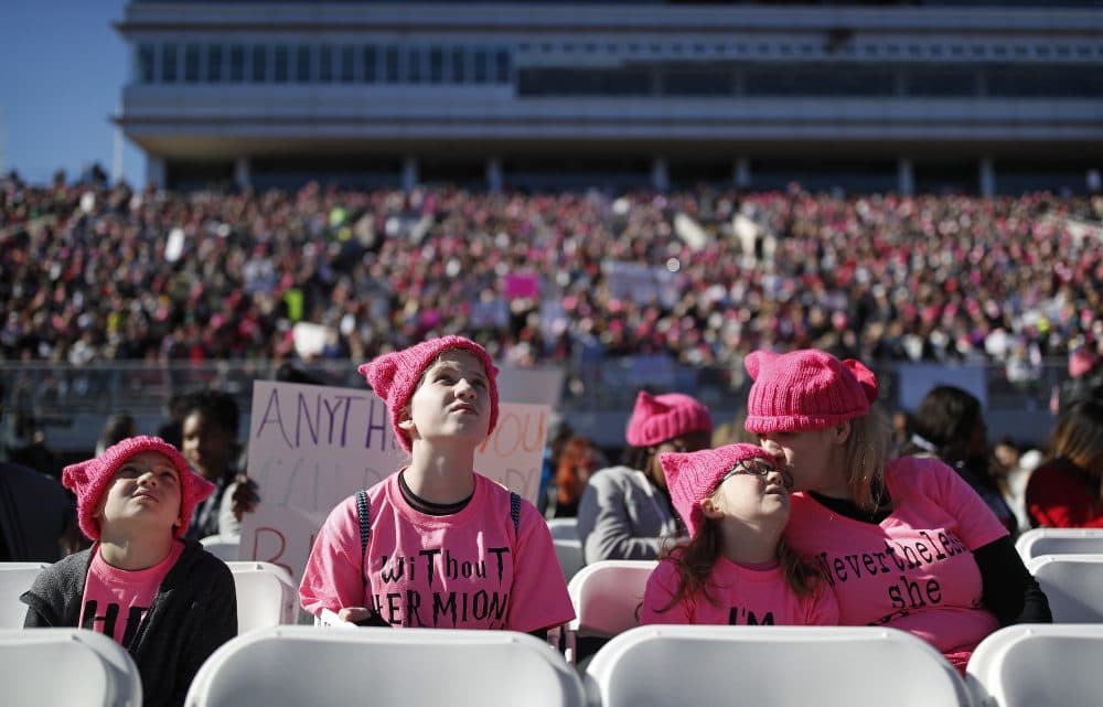 From right, Jennifer Rodis, and her children Zoe, Sophie and Chris listen to speakers during a Women's March rally, Sunday, Jan. 21, 2018, in Las Vegas. (John Locher/AP)