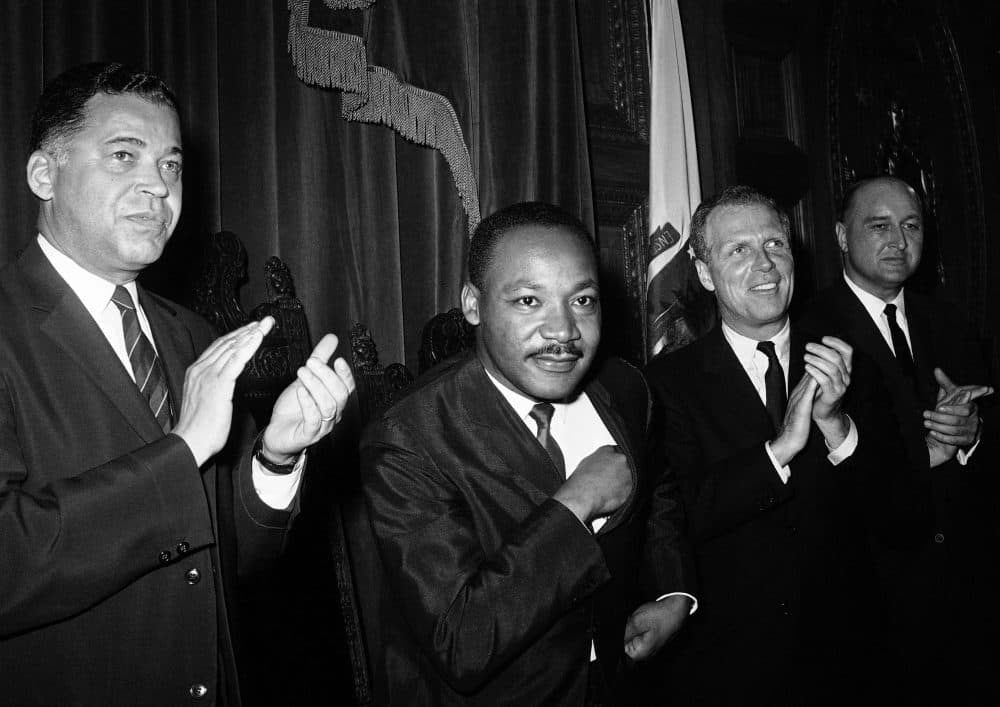 Dr. Martin Luther King Jr. sits down following his speech to the joint session of the Massachusetts Legislature in Boston on April 22, 1965. (AP)