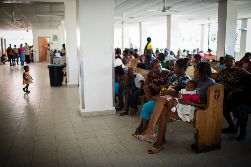 Patients wait outside Klinik Extern at University Hospital in Mirebalais, Haiti. (Cecille Joan Avila/ Partners In Health)