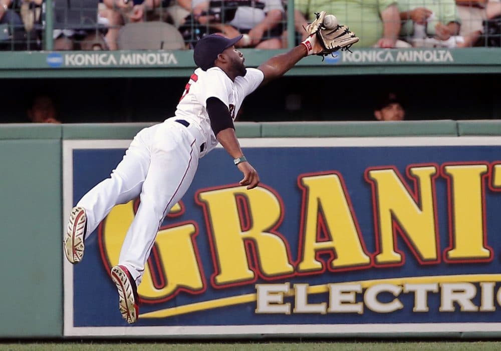 Boston Red Sox center fielder Jackie Bradley Jr. leaps to grab a deep fly by Chicago White Sox's Tyler Flowers in the second inning of a baseball game at Fenway Park in Boston, Wednesday, July 9, 2014. (AP Photo/Elise Amendola)