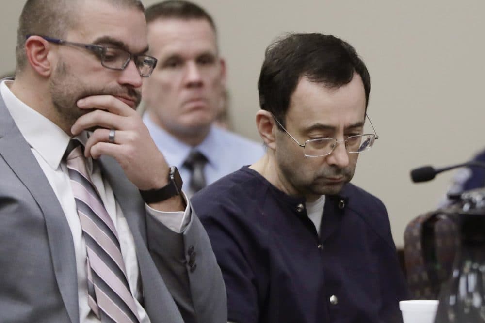 Larry Nassar sits with attorney Matt Newburg during his sentencing hearing Wednesday, Jan. 24, 2018, in Lansing, Mich. The former sports doctor who admitted molesting some of the nation's top gymnasts for years was sentenced Wednesday to 40 to 175 years in prison as the judge declared: &quot;I just signed your death warrant.&quot;  The sentence capped a remarkable seven-day hearing in which scores of Nassar's victims were able to confront him face to face in the Michigan courtroom.  (AP Photo/Carlos Osorio)