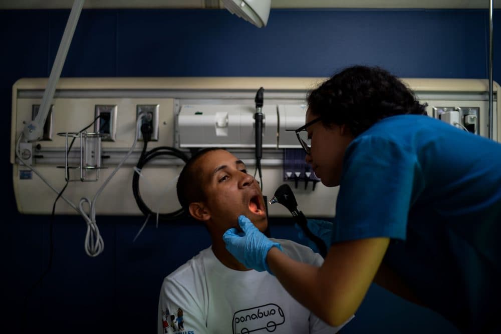 A volunteer doctor gives a homeless person a checkup on the PanaBus in Caracas on Nov. 27, 2017. (Federico Parra/AFP/Getty Images)
