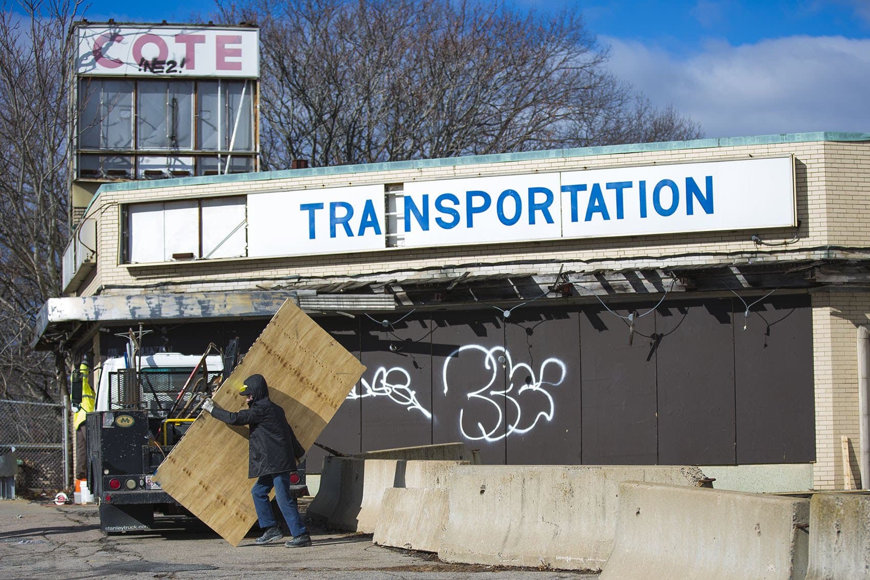 Contractors from Metro Equipment Corp. prepare the Cote building for inspection in Mattapan. (Jesse Costa/WBUR)