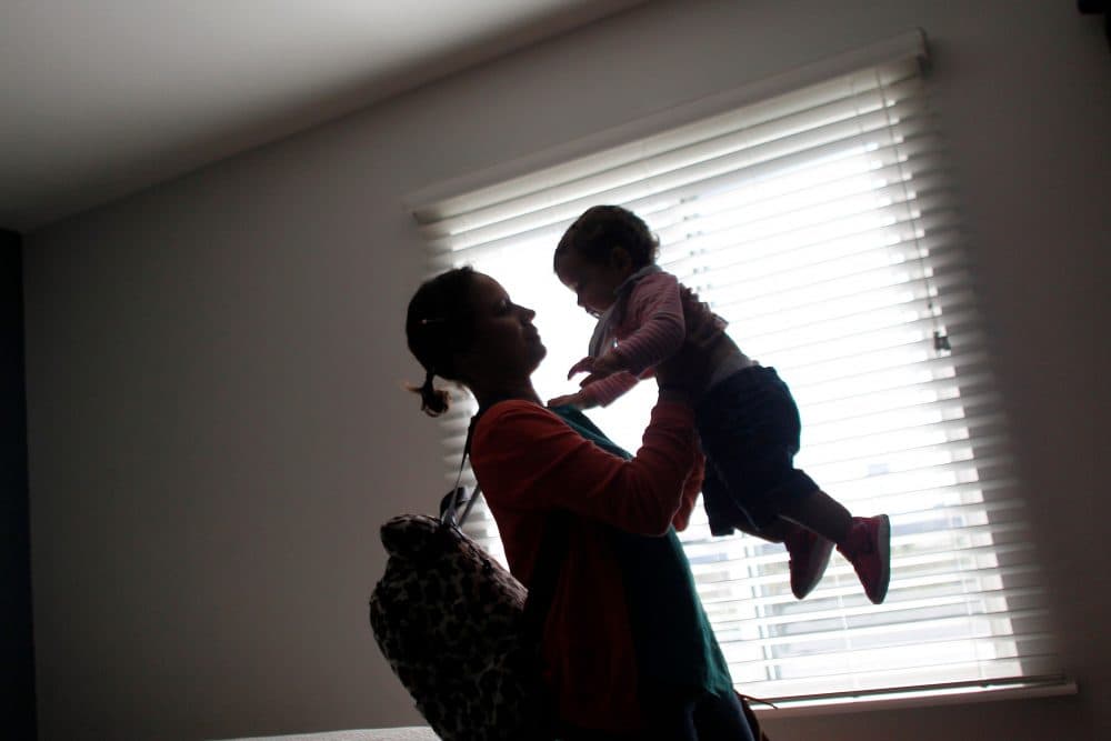 Deborah Oquendo, 42, carries her 10-month-old daughter Genesis Rivera at the hotel where they are staying in Orlando, Fla., on Dec. 1, 2017. (Ricardo Arduengo/AFP/Getty Images)