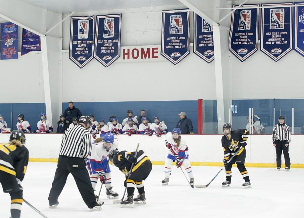 Assabet Valley U-14s face off under a wall of national championship banners. (Robin Lubbock/WBUR)