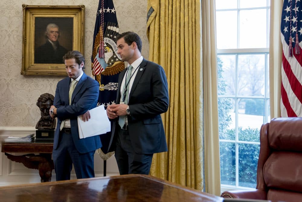 Treasury Secretary Steve Mnuchin's Chief of Staff Eli Miller, left, and then-White House Staff Secretary Rob Porter, right, stand in the Oval Office as President Donald Trump speaks at a tax reform meeting with American workers at the White House, Wednesday, Jan. 31, 2018, in Washington. (Andrew Harnik/AP)