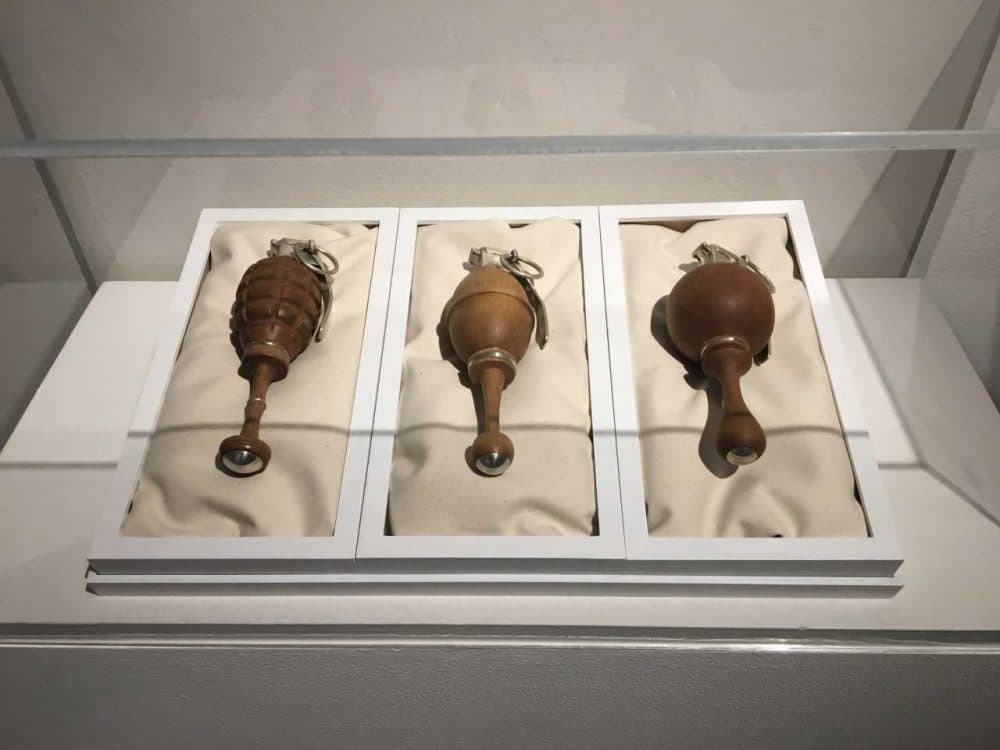 &quot;Three Generations,&quot; 2013 functional hand turned hardwood and sterling grenade baby rattles. (Andrea Shea/WBUR)