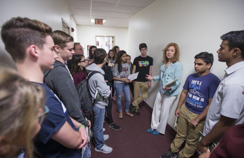 Florida Rep. Kristin Jacobs talks with student survivors from Marjory Stoneman Douglas High School in the hallway at the Florida Capitol in Tallahassee, Fla., Feb 21, 2018. (Mark Wallheiser/AP)