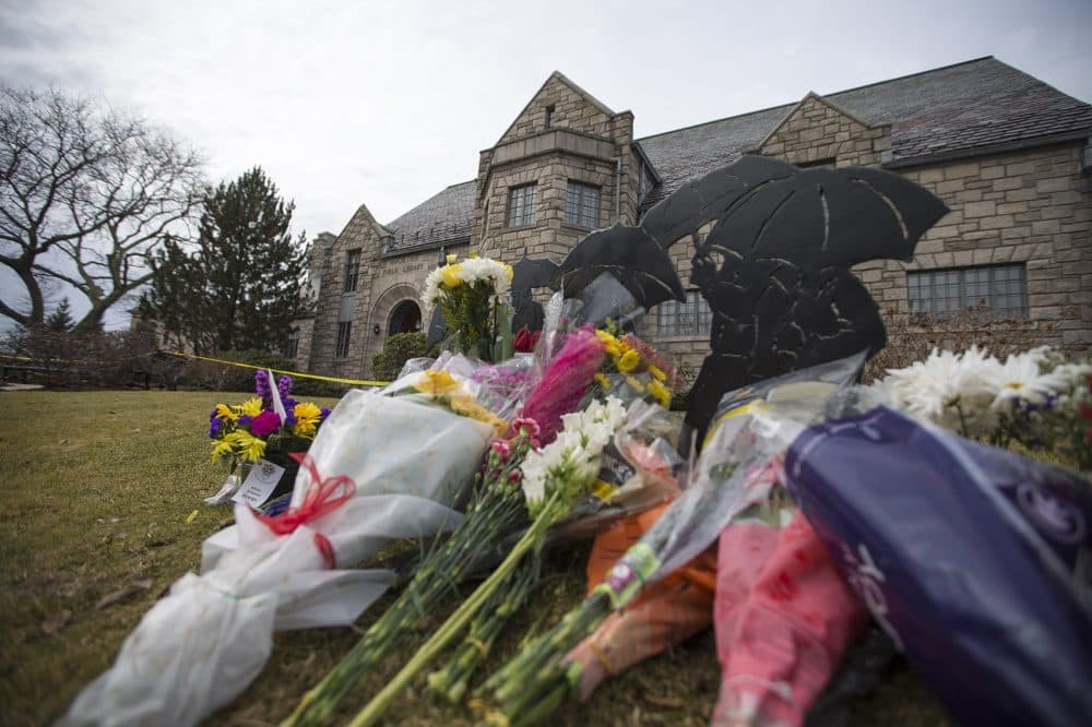 A row of flowers are left in memory of 22-year-old Deane Stryker in front of the Winchester library.(Jesse Costa/WBUR)