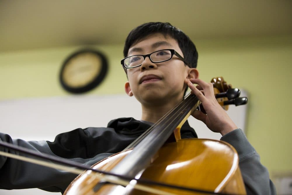 Boston Latin student and member of the Boston String Academy Erick Liang, 14, rehearses on the cello. (Jesse Costa/WBUR)