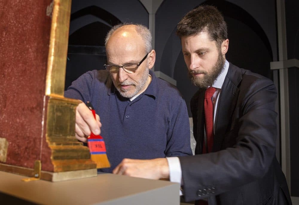 Gardner Museum's Gianfranco Pocobene and Nat Silver work on the display of Fra Angelico's work. (Robin Lubbock/WBUR)