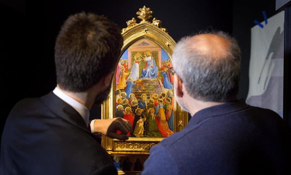 The Gardner Museum's Nat Silver and Gianfranco Pocobene examine Fra Angelico's "Coronation of the Virgin," which is on loan from a museum in Florence. (Robin Lubbock/WBUR)