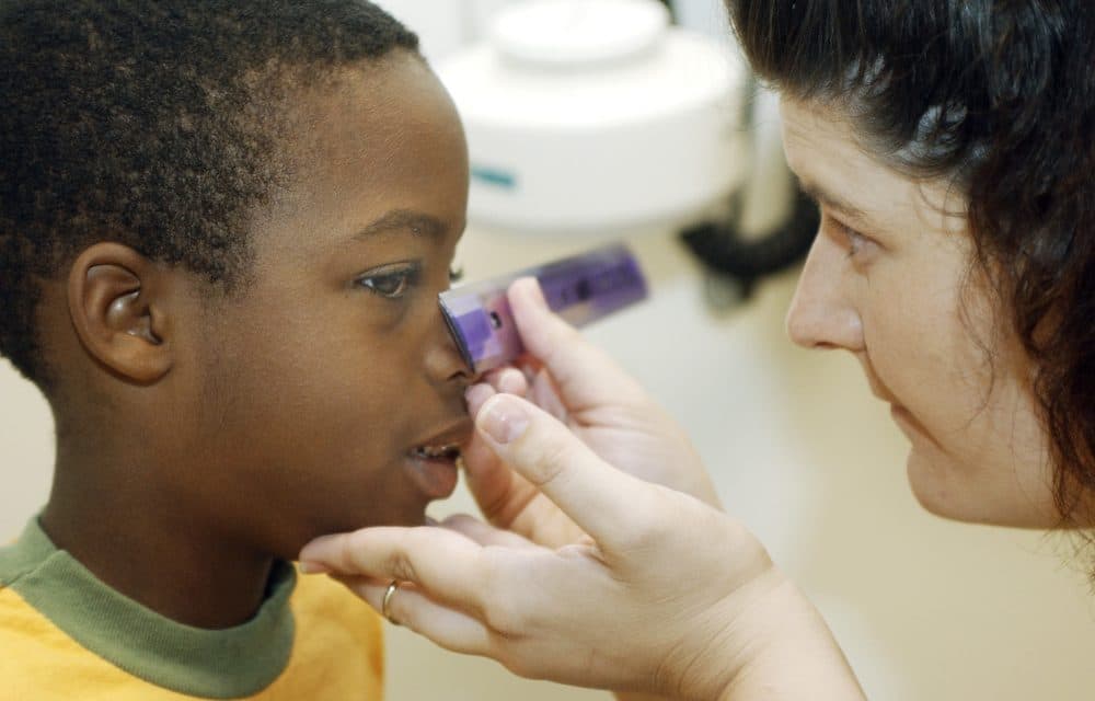 Amanda Dreasher, a public health nurse, measures a boy's eyes in 2003, in Emporia, Kan., at the Fetal Alcohol Syndrome Clinic. (David Doemland/AP)